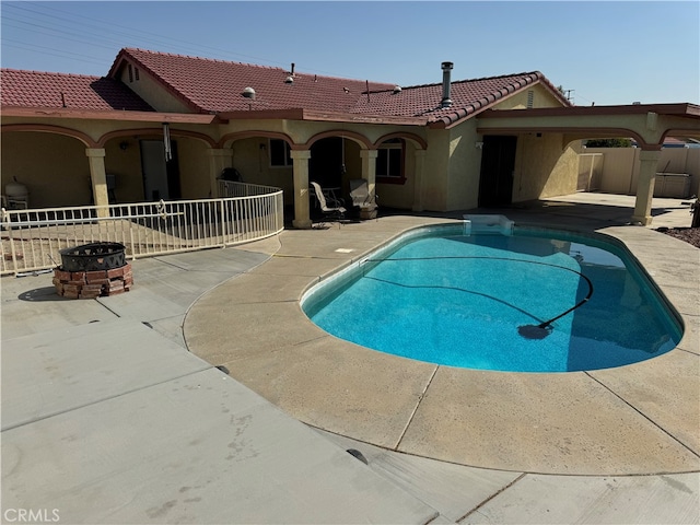 view of pool featuring a patio and an outdoor fire pit