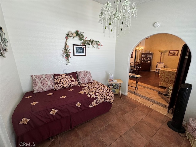 tiled bedroom with an inviting chandelier