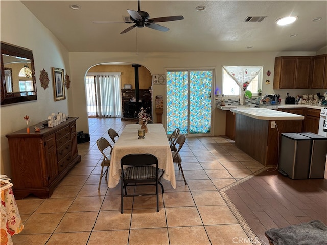 dining space with light tile patterned floors and ceiling fan