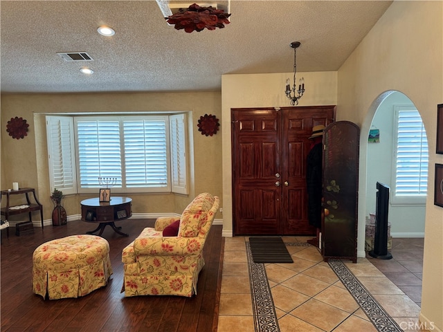 entryway featuring a textured ceiling, light hardwood / wood-style flooring, and plenty of natural light