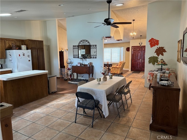 dining room with high vaulted ceiling, ceiling fan, and light tile patterned floors