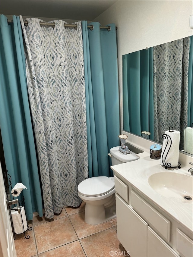 bathroom with vanity, toilet, and tile patterned floors