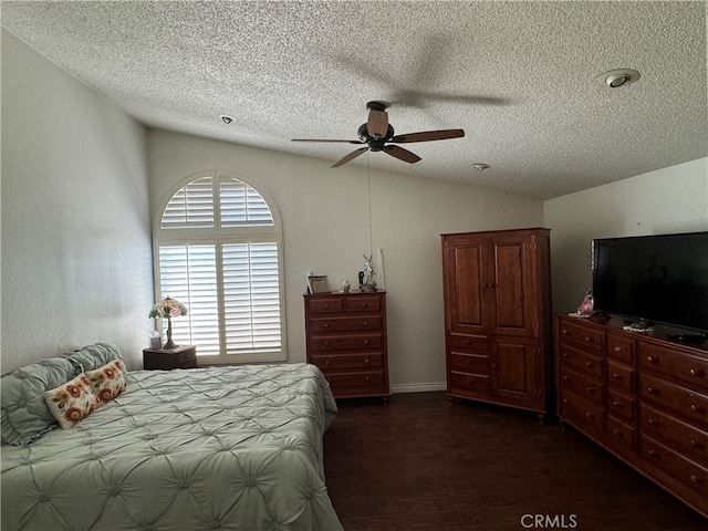 bedroom featuring a textured ceiling, lofted ceiling, ceiling fan, and dark wood-type flooring