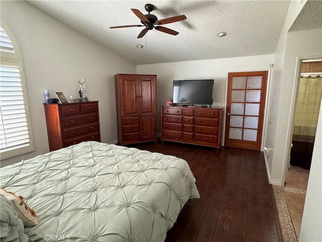 bedroom with dark hardwood / wood-style floors, a textured ceiling, ensuite bath, and ceiling fan