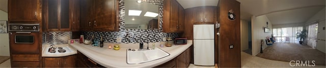 kitchen featuring sink, tasteful backsplash, and black appliances