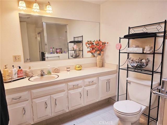 bathroom featuring vanity, tile patterned floors, a shower with shower door, and toilet