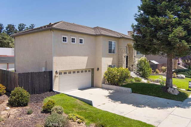 view of front of home featuring a garage and a front yard