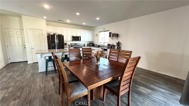 dining room with dark hardwood / wood-style flooring