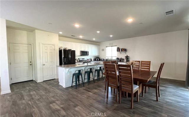 dining room with dark hardwood / wood-style flooring