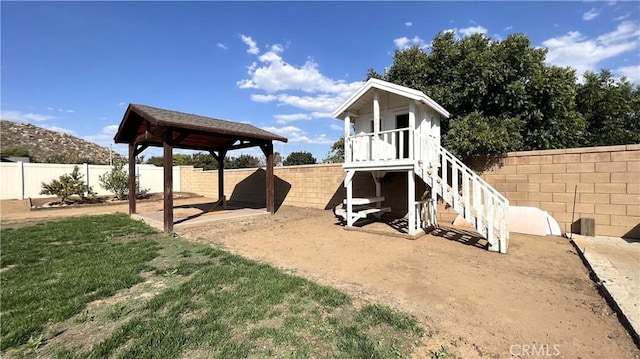 exterior space with a gazebo and a lawn