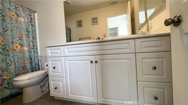 bathroom featuring a shower with curtain, vanity, toilet, and tile patterned flooring