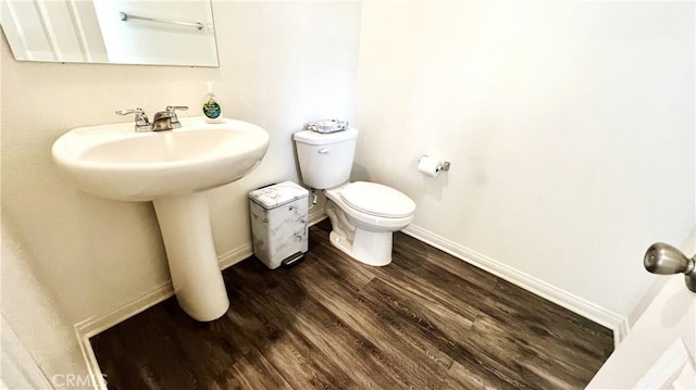 bathroom with sink, toilet, and hardwood / wood-style floors