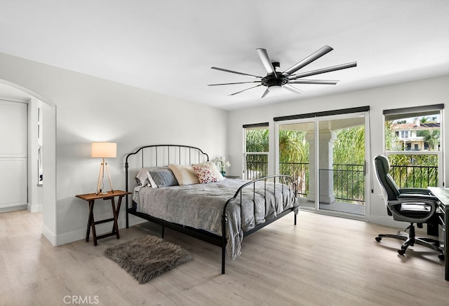 bedroom featuring ceiling fan, light hardwood / wood-style floors, and access to outside