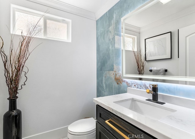 bathroom featuring crown molding, vanity, and toilet