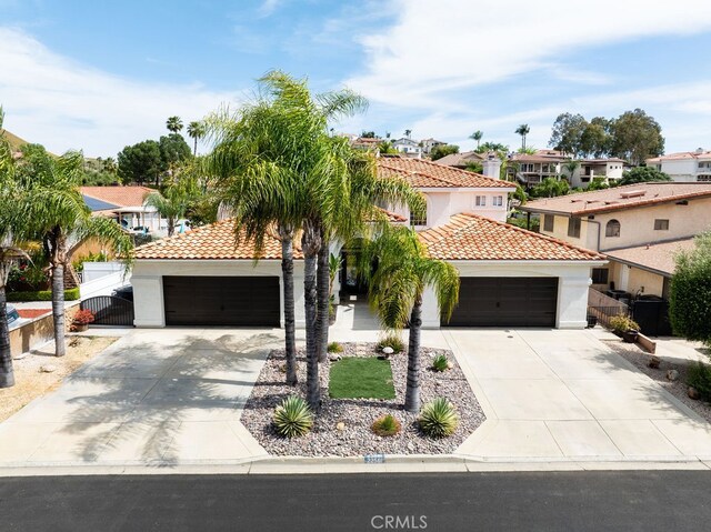 mediterranean / spanish-style home with a garage