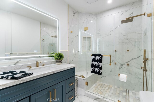 bathroom featuring walk in shower and vanity