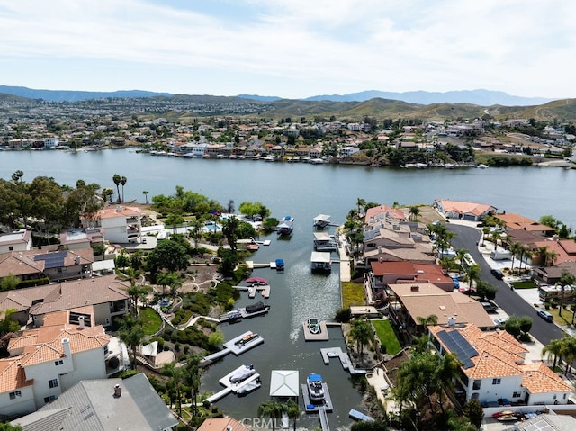 drone / aerial view featuring a water and mountain view