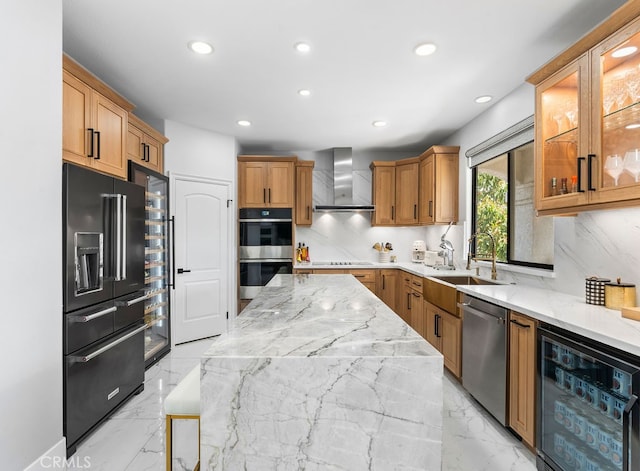 kitchen with light stone counters, sink, beverage cooler, wall chimney exhaust hood, and stainless steel appliances