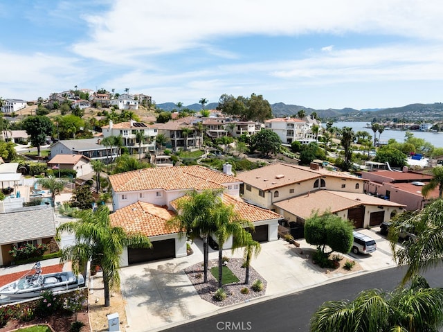 birds eye view of property featuring a water and mountain view