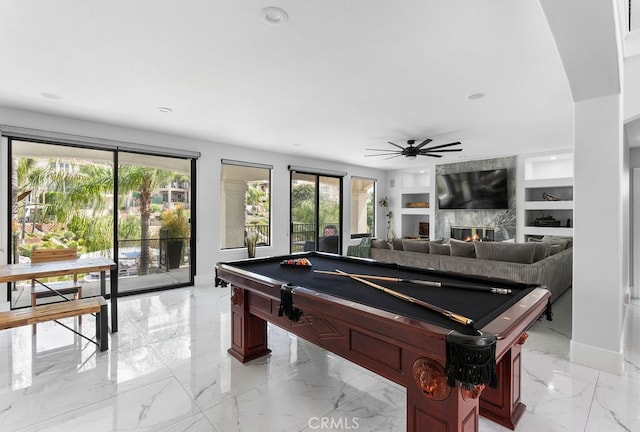 game room with pool table, built in shelves, a fireplace, and ceiling fan