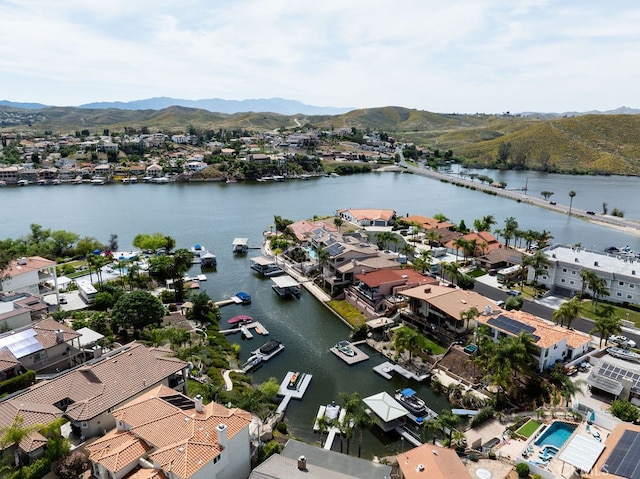 birds eye view of property featuring a water and mountain view