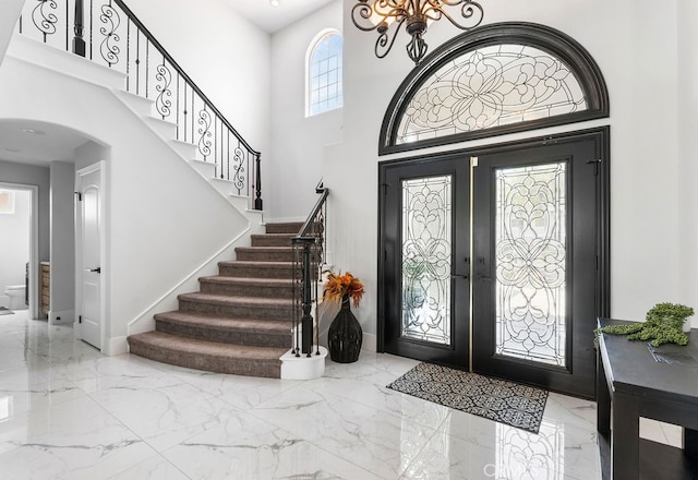 foyer entrance featuring a high ceiling and french doors