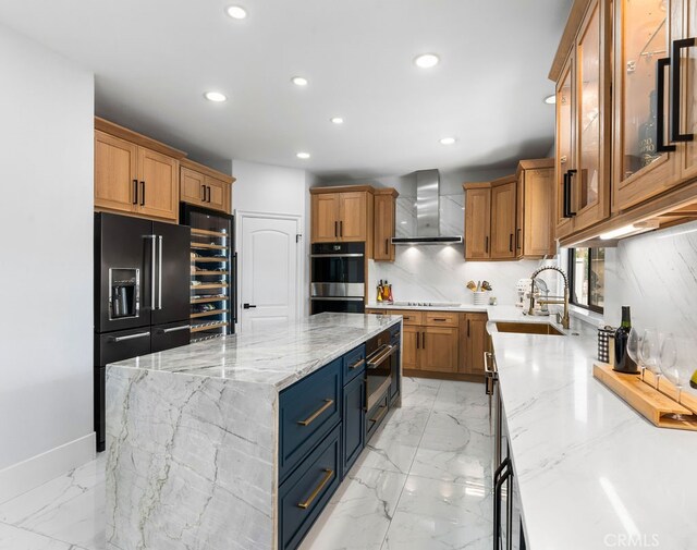 kitchen with a large island, light stone counters, black fridge with ice dispenser, and wall chimney range hood