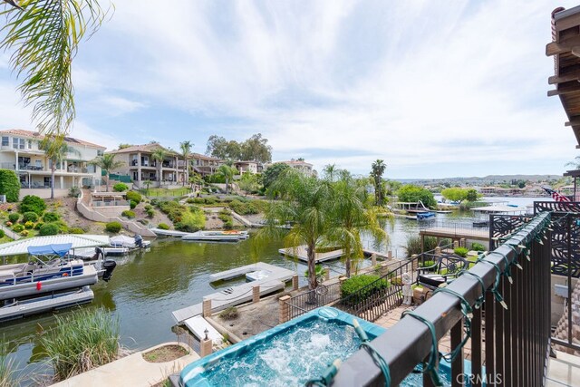 exterior space with a water view and a dock