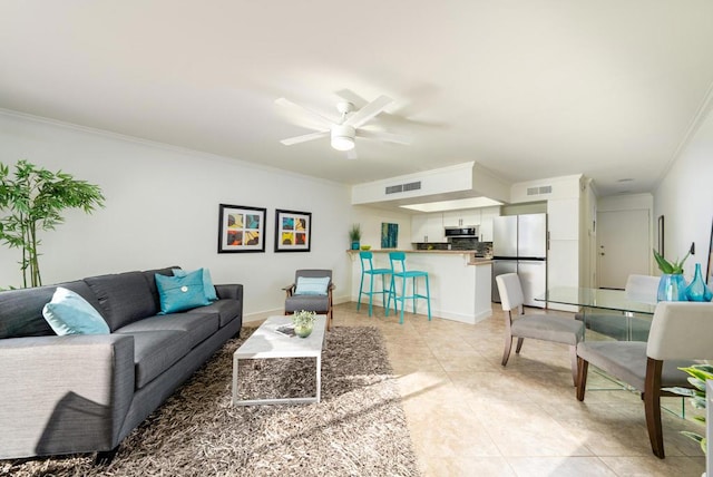 living room with ceiling fan, light tile patterned floors, and crown molding