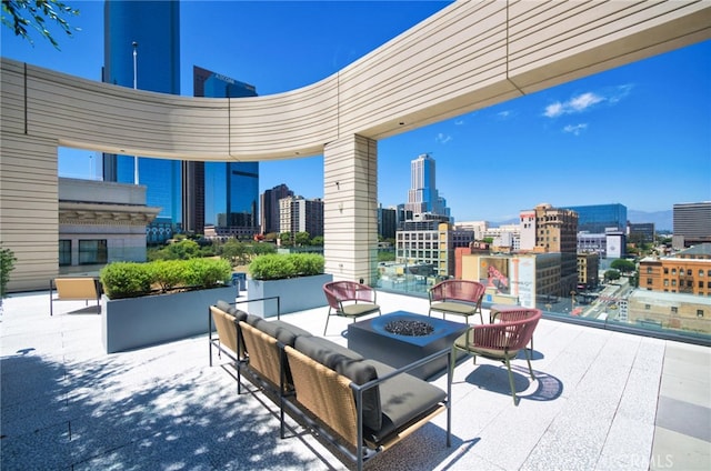 view of patio / terrace with an outdoor living space with a fire pit