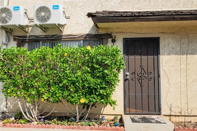 doorway to property featuring ac unit