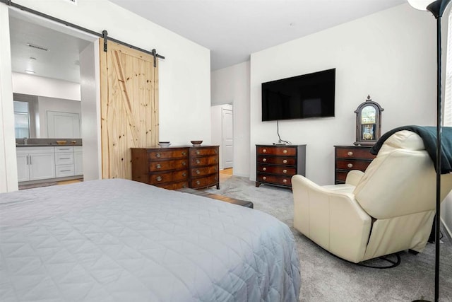 2013 Bravo Loop Unit 5, Chula Vista, CA 91915 - bedroom featuring light carpet, a barn door, and ensuite bathroom