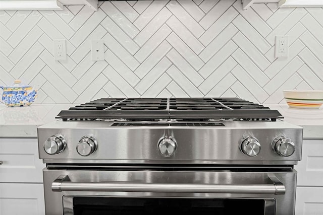 2013 Bravo Loop Unit 5, Chula Vista, CA 91915 - kitchen view of stainless steel gas stove, backsplash, and white cabinets