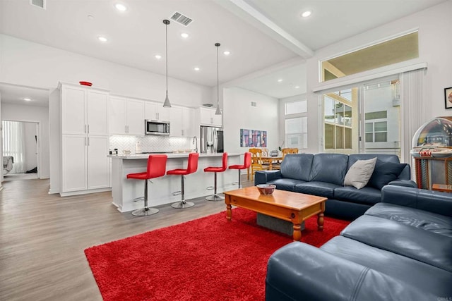2013 Bravo Loop Unit 5, Chula Vista, CA 91915 - living room with light wood-style floors, beamed ceiling, and recessed lighting
