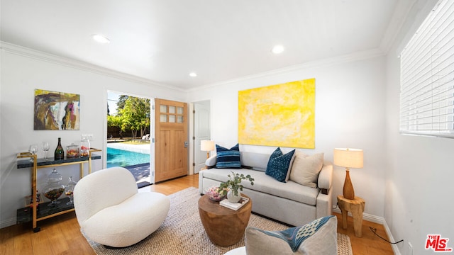 living room with ornamental molding and light wood-type flooring