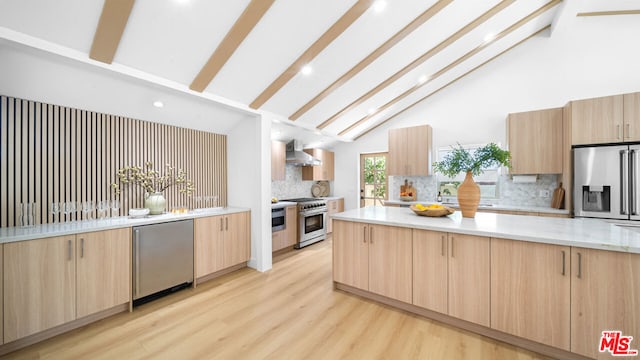 kitchen with tasteful backsplash, appliances with stainless steel finishes, light brown cabinetry, and light hardwood / wood-style flooring