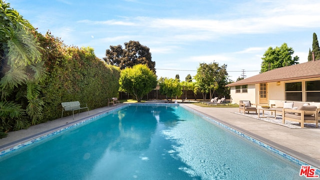 view of swimming pool featuring a patio area