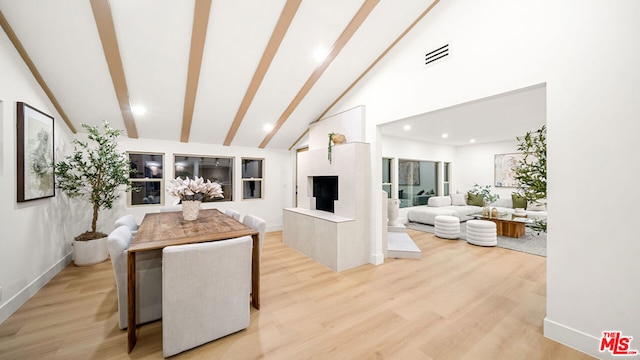 interior space featuring high vaulted ceiling and light hardwood / wood-style floors