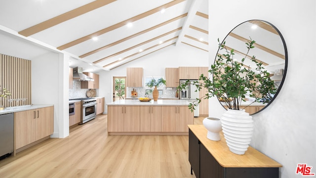 kitchen with a center island, wall chimney range hood, backsplash, and premium appliances