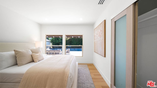 bedroom with light wood-type flooring