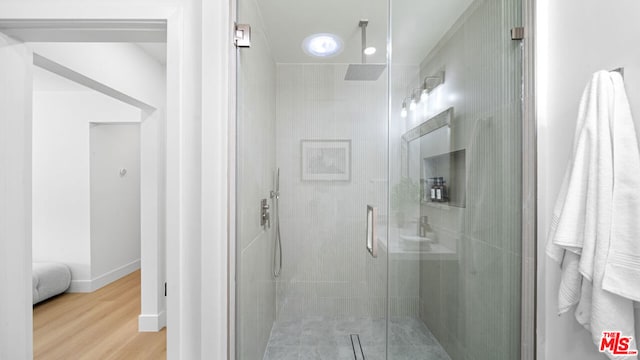 bathroom with hardwood / wood-style floors and walk in shower