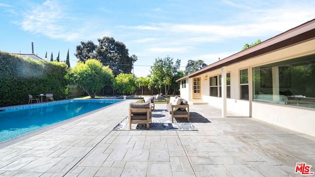 view of swimming pool featuring a patio area