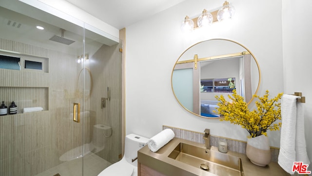 bathroom with an enclosed shower, vanity, and toilet