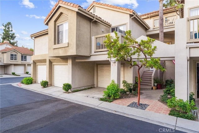 townhome / multi-family property with a balcony and a garage