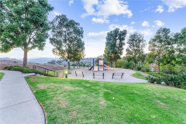 view of play area featuring a mountain view and a yard