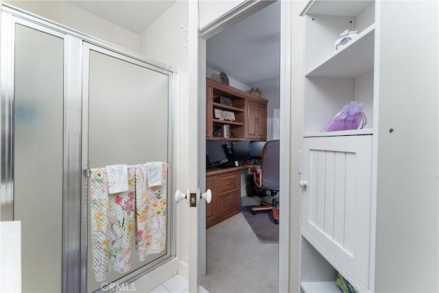 bathroom featuring a shower with door