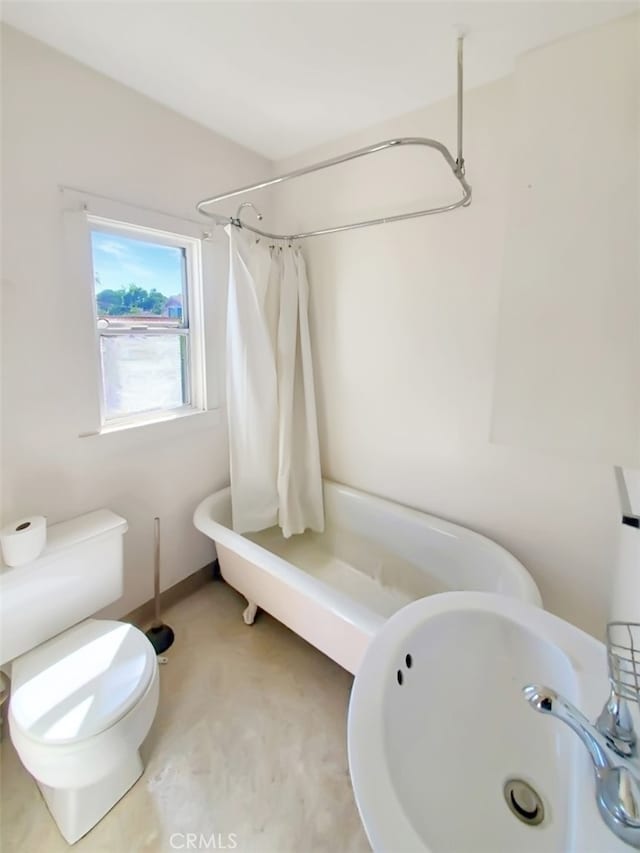 bathroom with sink, toilet, and a shower with shower curtain