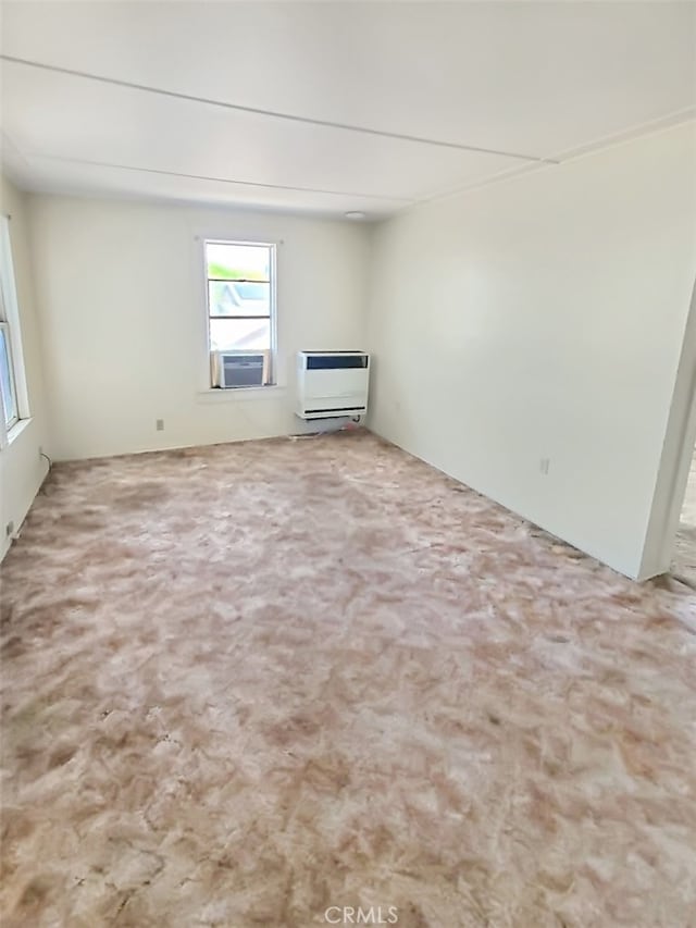 carpeted empty room featuring cooling unit and heating unit