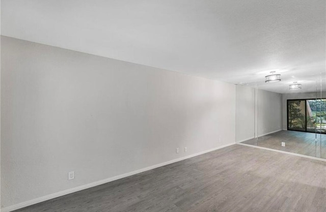 empty room featuring hardwood / wood-style flooring