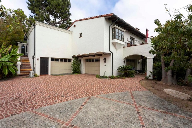 mediterranean / spanish home with a balcony and a garage